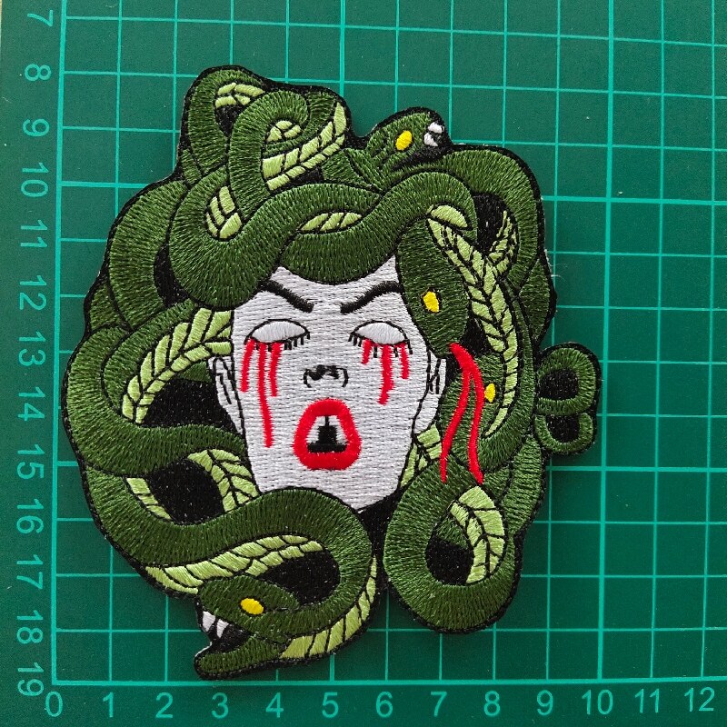 Medusa woman with green snakes hair and red tears patch
