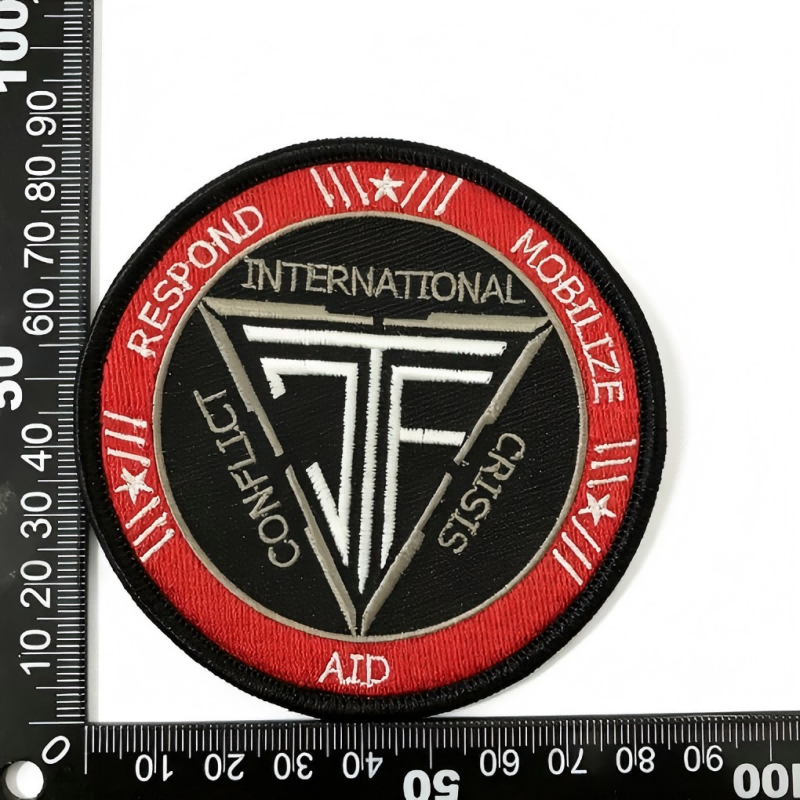 Round black and red TF crisis response emblem patch