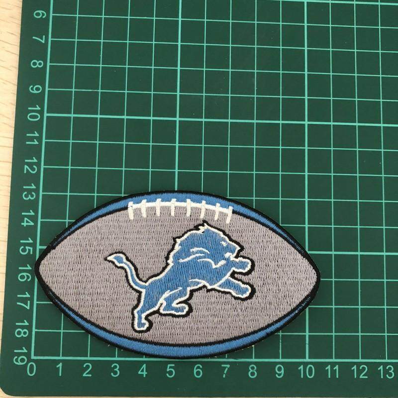 Detroit Lions football team logo patch on green cutting mat
