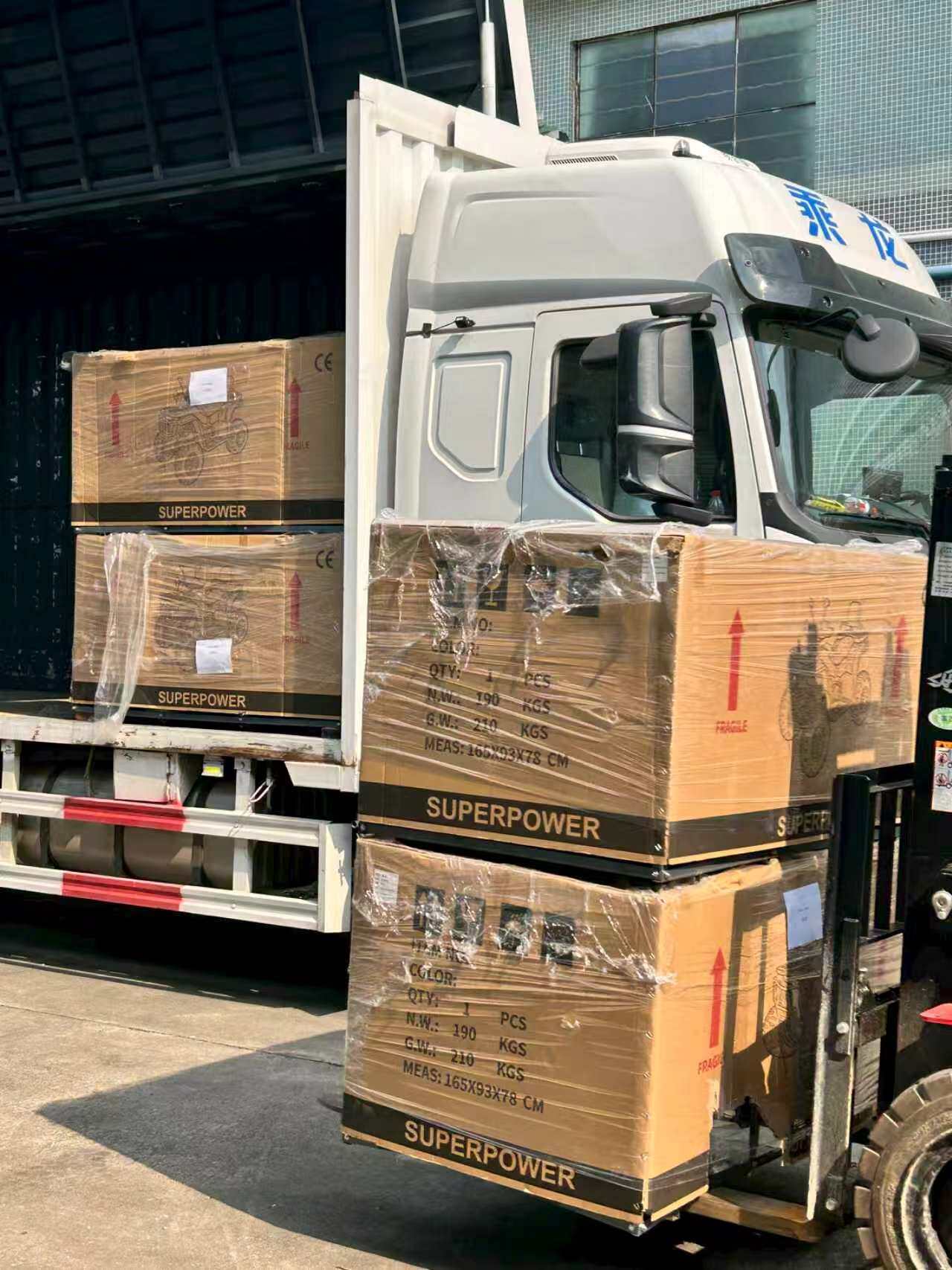 Forklift loading export-packed go-kart crates onto freight truck at Changfeng Kart factory