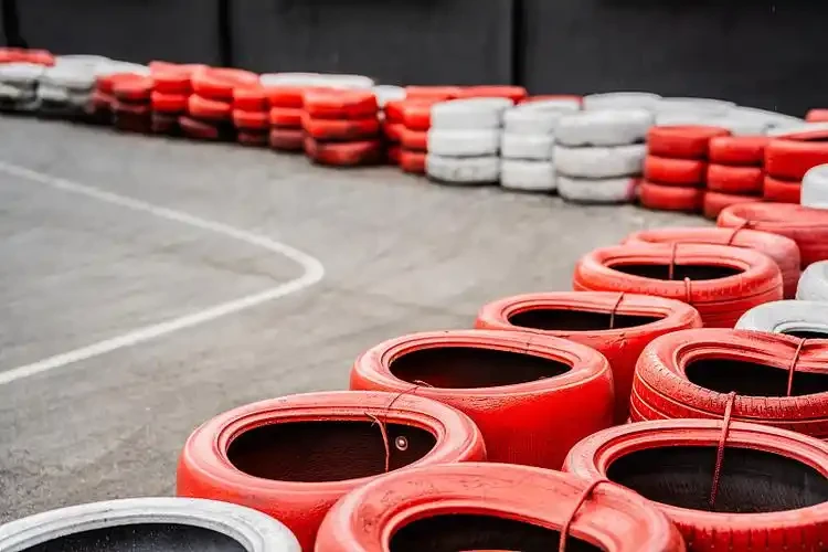 Professional go-kart safety equipment including helmets, driving suits, gloves, and protective gear