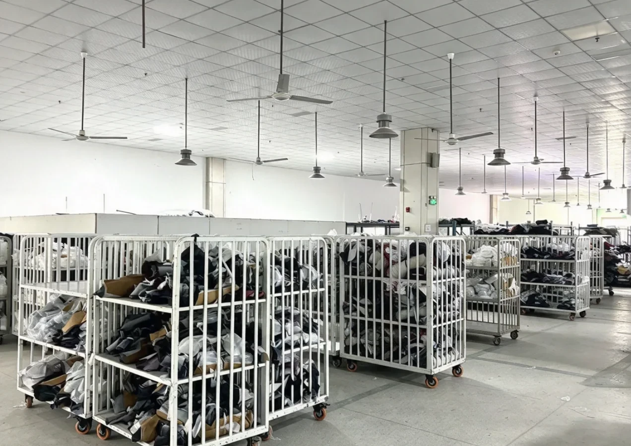 Finished goods warehouse with rolling storage cages at our own Anqing Wangjiang Apparel factory