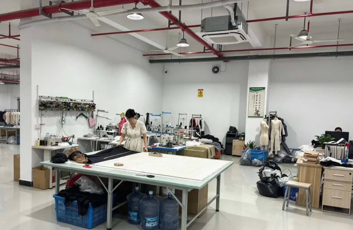 Pattern making and sample room at our own Anqing Wangjiang Apparel factory with cutting table, sample machines and mannequins