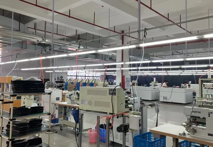 Heat-sealing machines and workstations in the heat-sealing workshop of our own Anqing Wangjiang Apparel factory