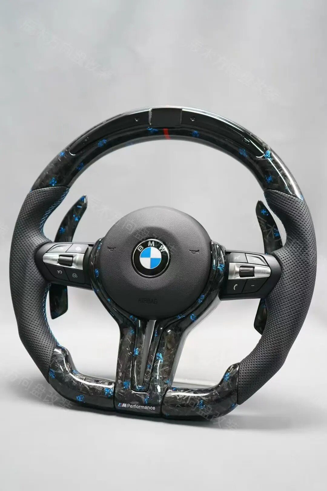 Carbon fiber weave pattern detail on BMW F30 steering wheel