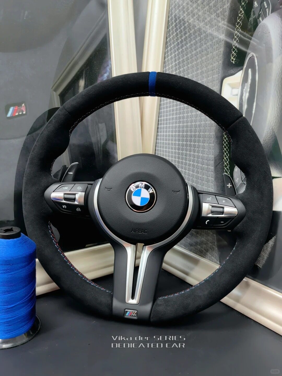 Alcantara stitching craftsmanship detail on BMW F30 steering wheel