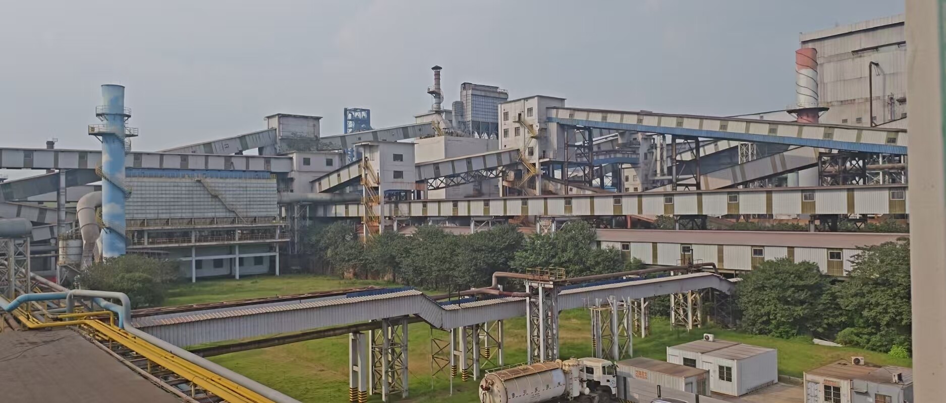 Steel plant panorama with sintering workshops, conveyor galleries and stacks