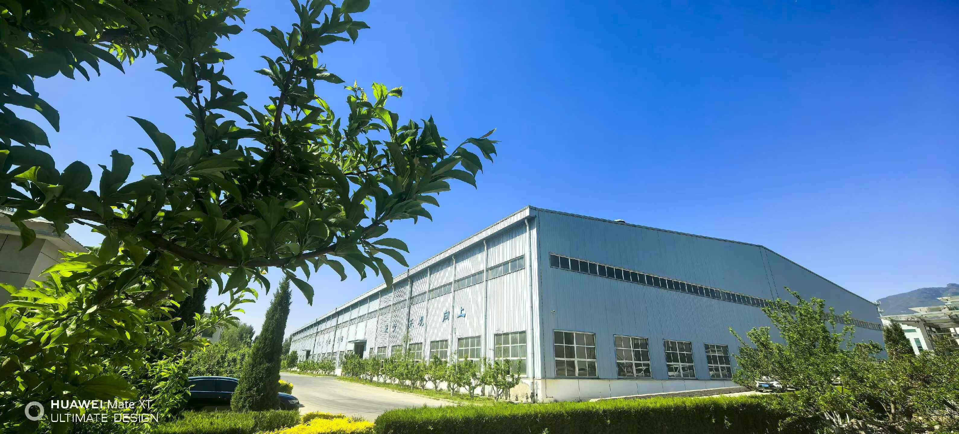 GANGPU manufacturing workshop building with landscaped frontage under clear sky