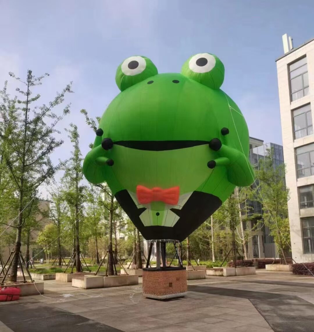 Frog Prince Tethered Balloon – A green frog with a red bow tie, perfect for themed events, scenic attractions, and children's parks. Unique design that catches the eye.