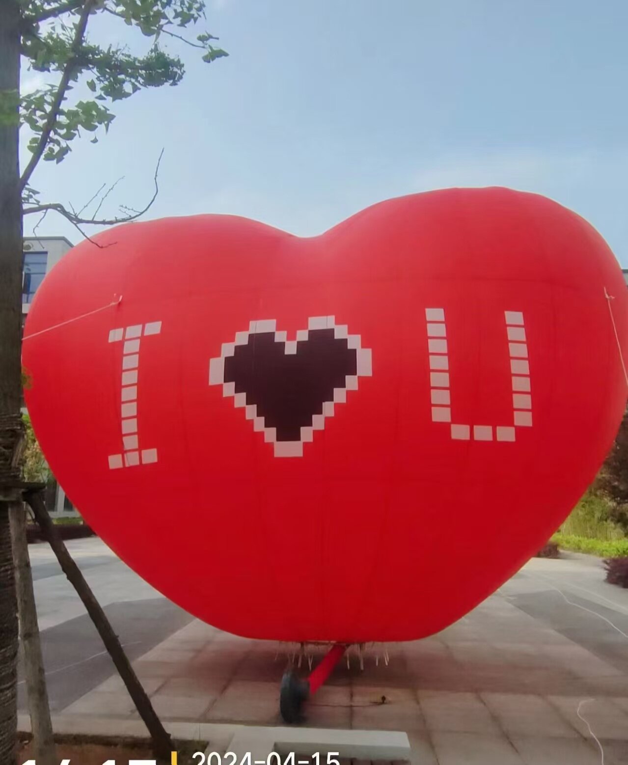 I LOVE U Heart Balloon - Red helium-filled heart balloon featuring "I LOVE U" pixel font, perfect for Valentine's Day, weddings, and romantic events. Customizable.