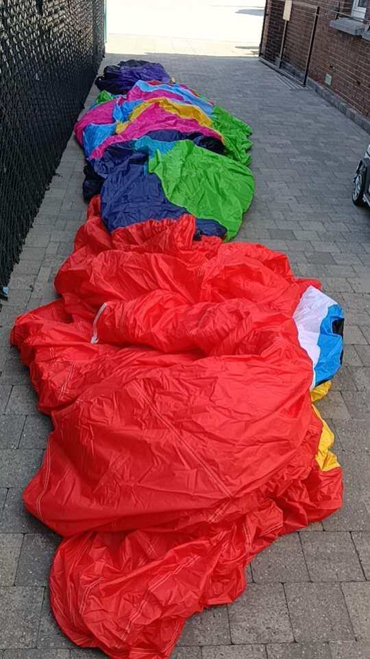 Rooster RC Balloon Shipment to Belgium - Colorful Envelope Fabric Yiwei Balloons rooster shaped RC balloon colorful envelope fabric laid out on ground before packing for Belgium shipment