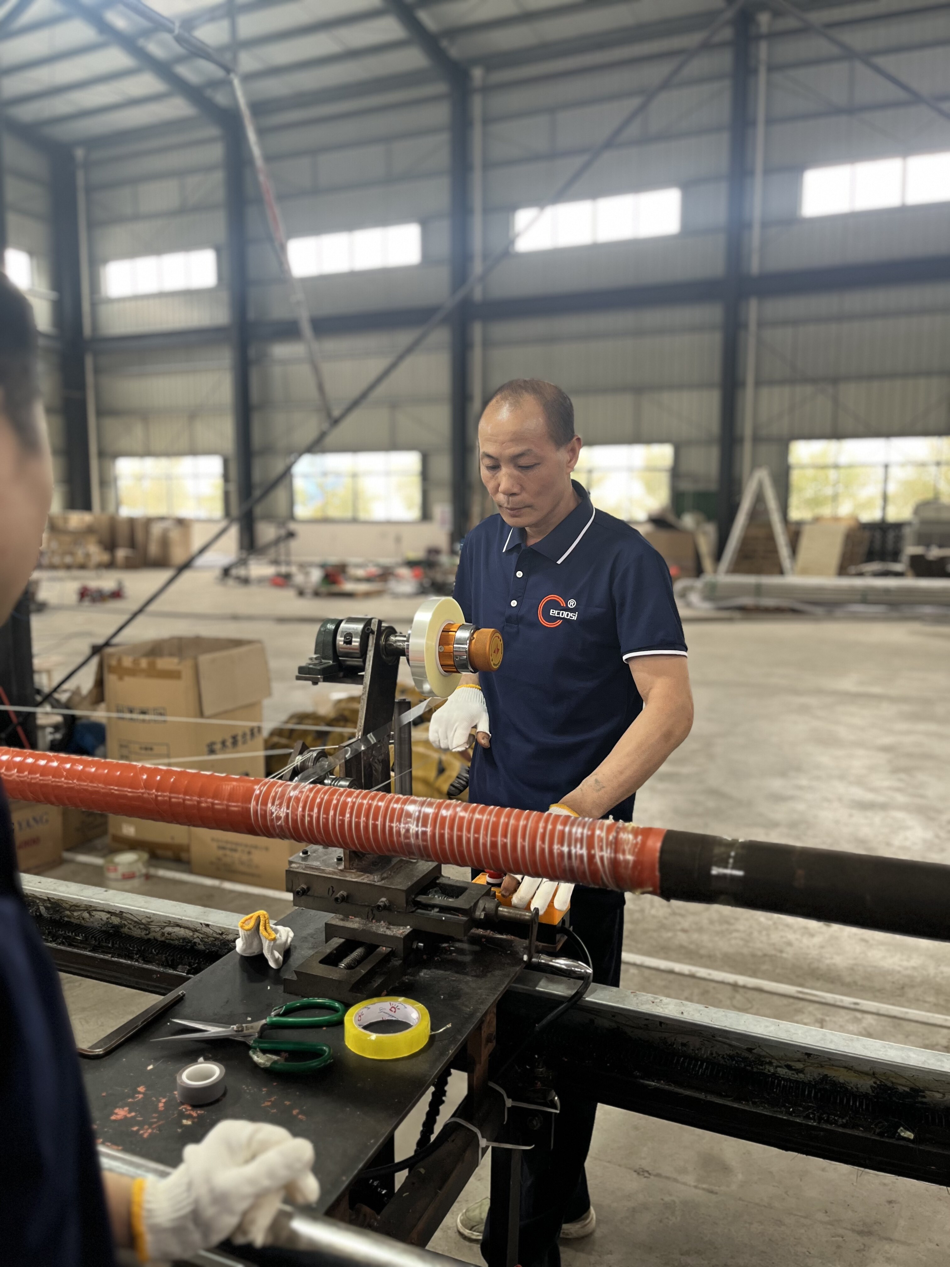 Technician operating duct hose cutting machine