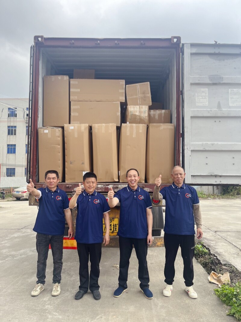 Shipping team giving thumbs up at container loading site
