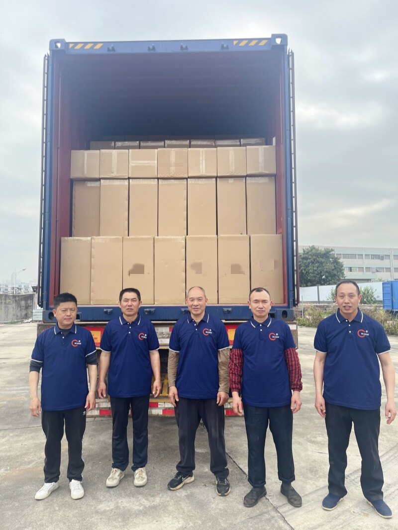 Team standing in front of loaded shipping container