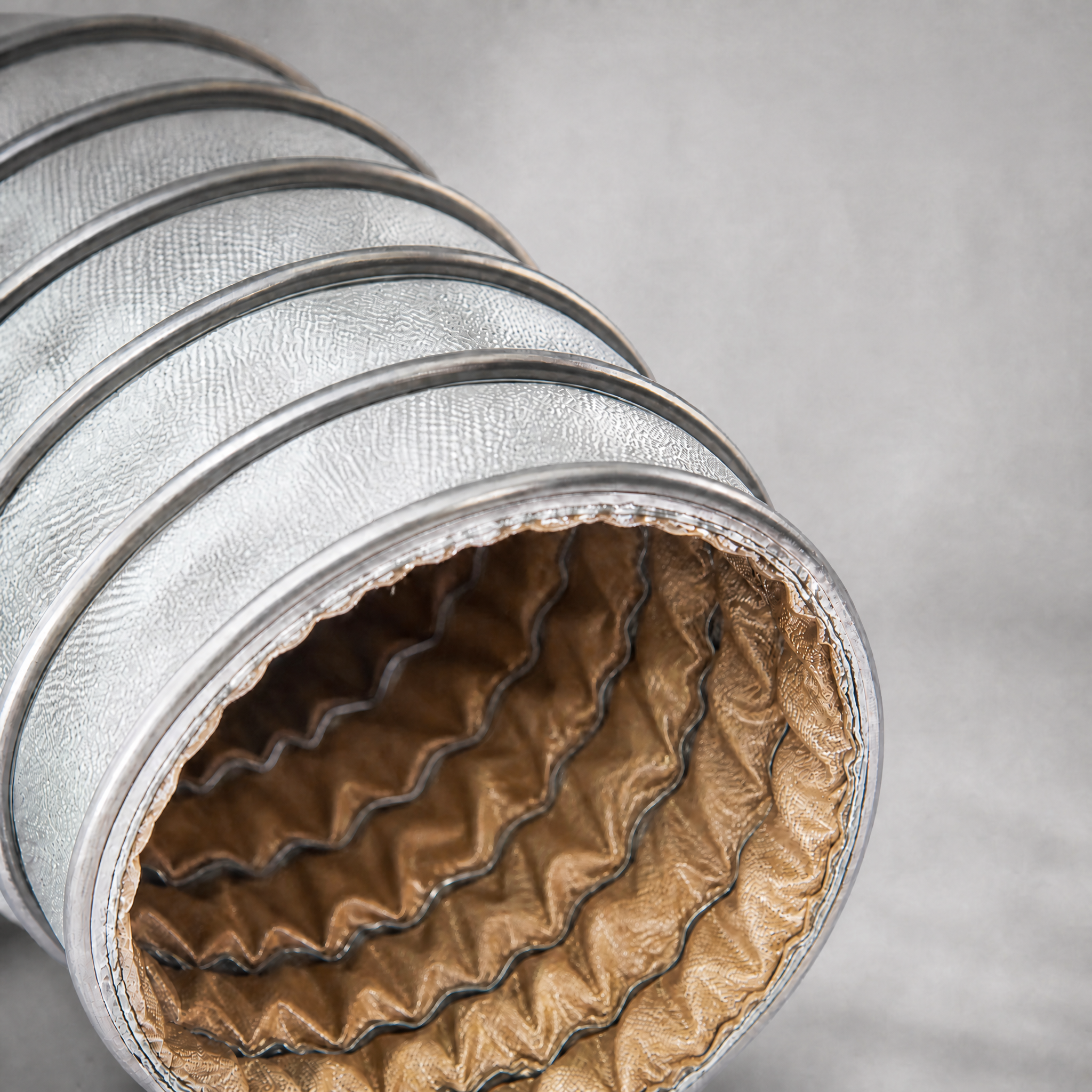 Customized Length High Temp Duct - close-up of silver duct with brown inner lining showing custom length