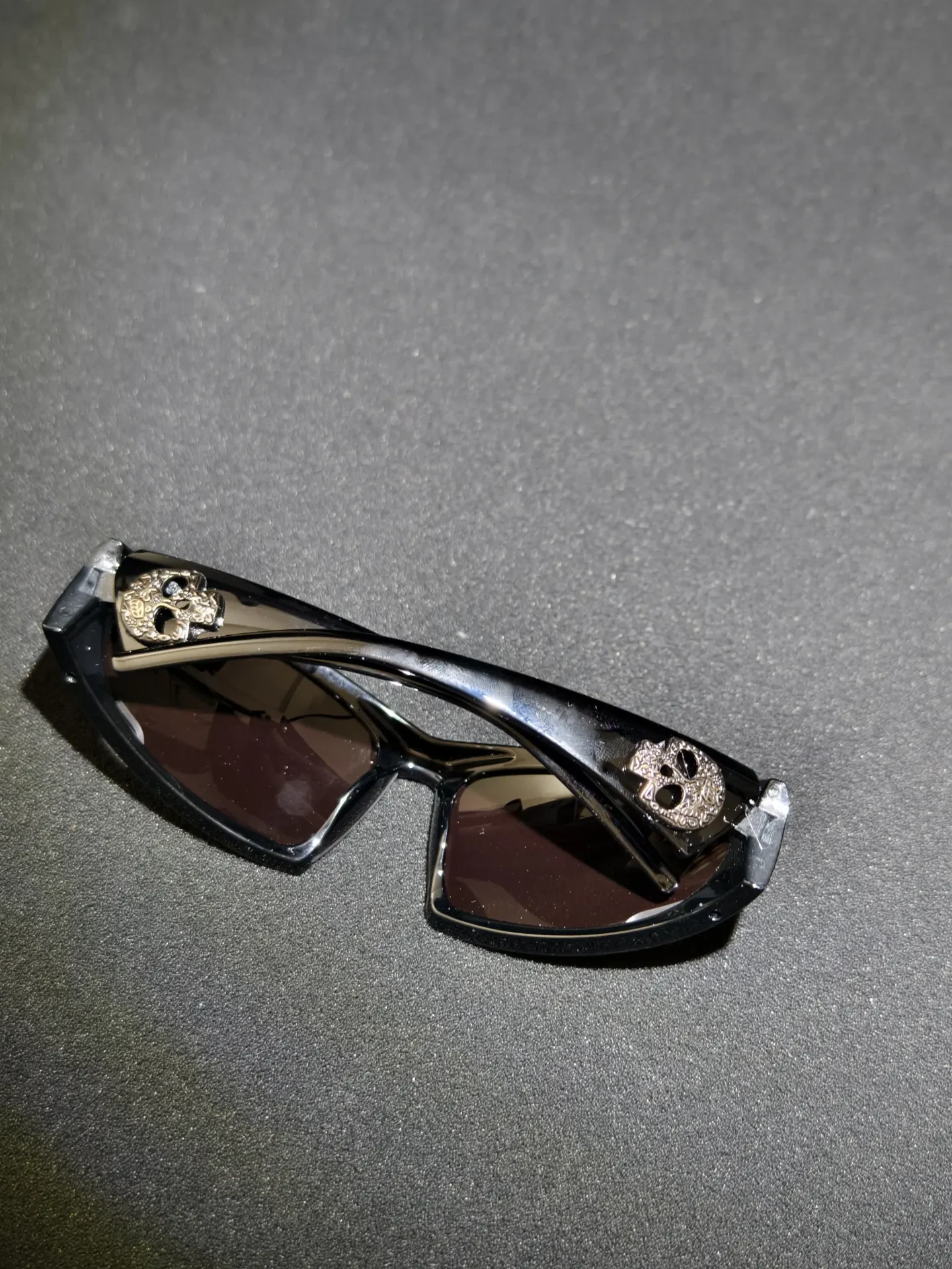 Twin Mark Shades — Wrapped frame with twin skull marks and a brown-tinted lens.