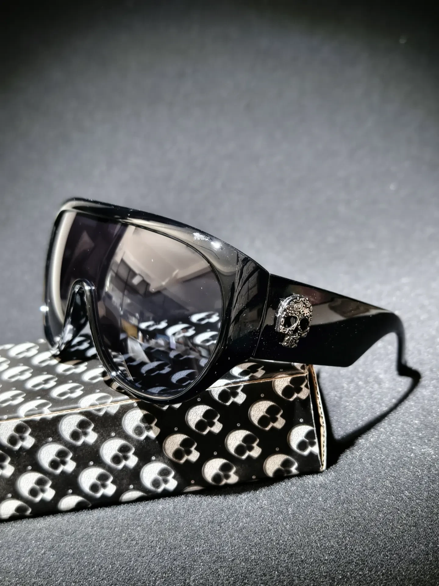 Wideguard Skull Shades — Wide shield front with a silver skull on the temple.