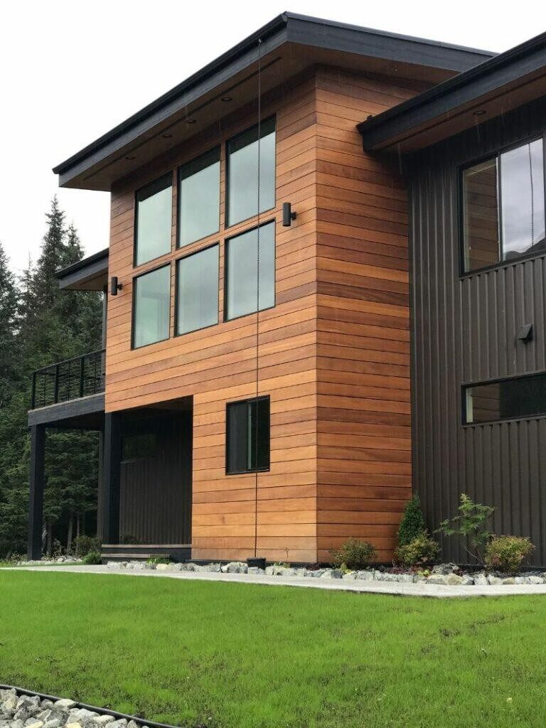Modern home with warm wood-tone aluminum siding and dark accents