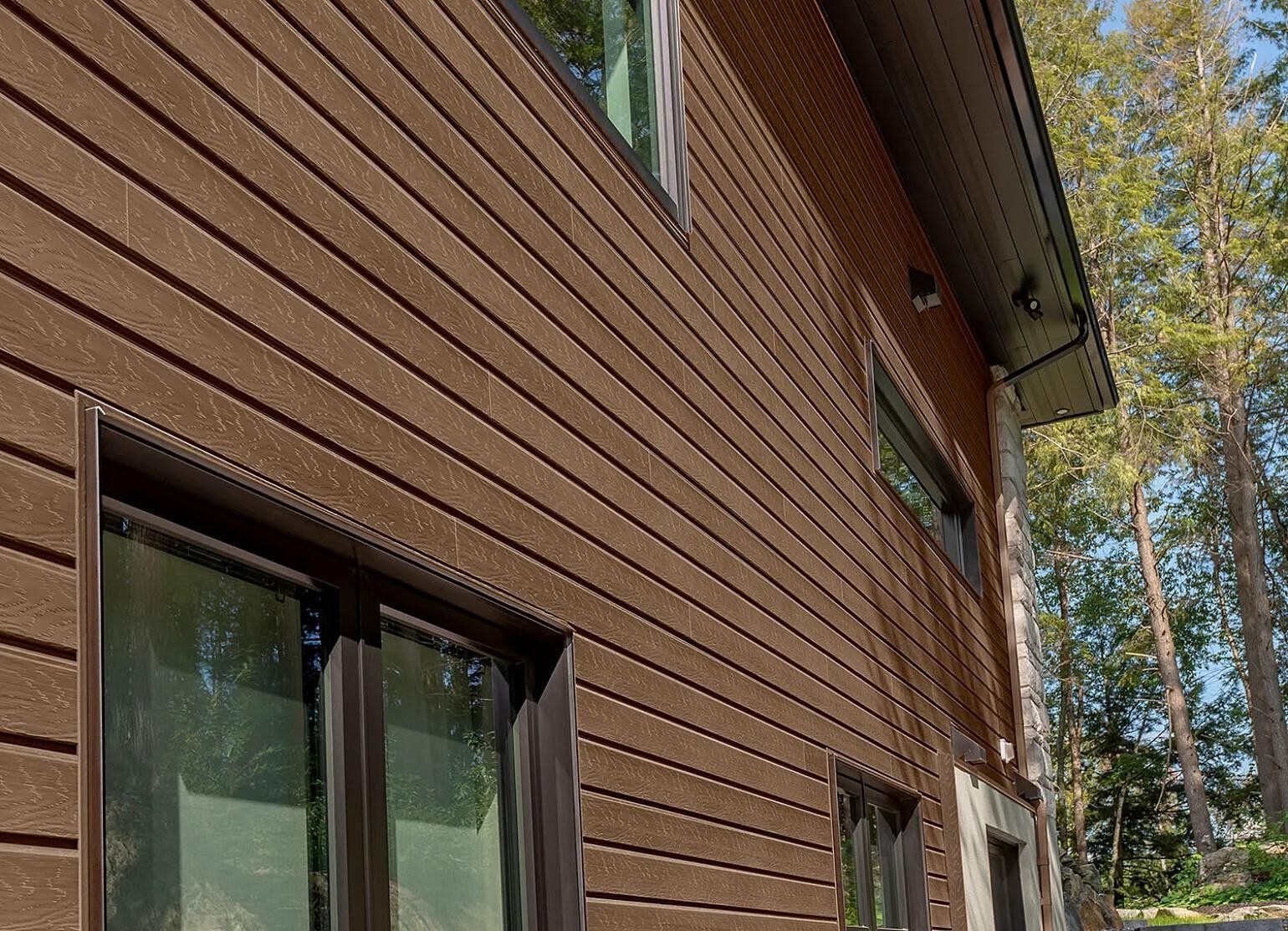 Close-up of brown wood grain aluminum siding on residential home