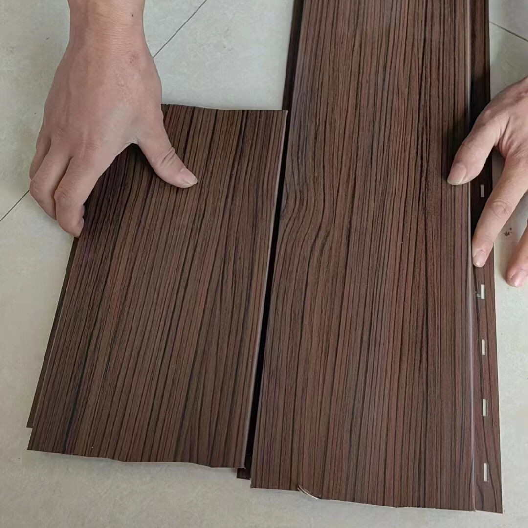 Hands installing wood grain aluminum siding panels
