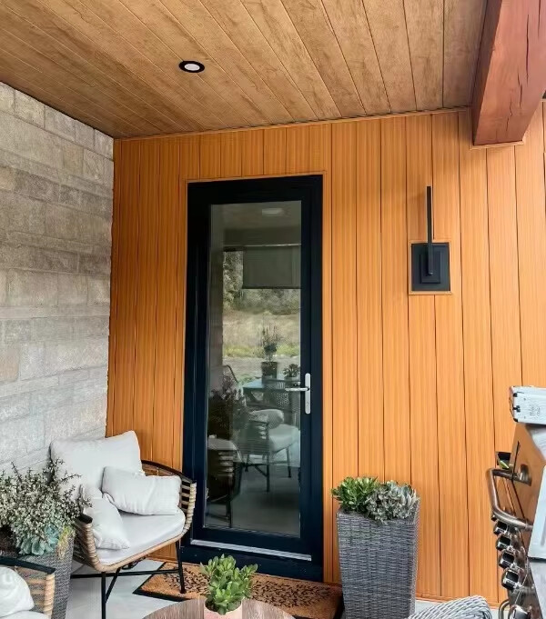 After: new aluminum siding in rich wood grain finish