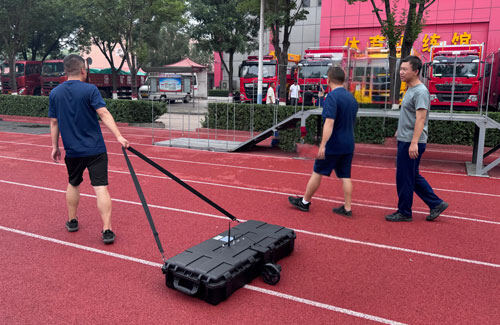 Multiple staff members dragged the SL-TGPR ground-penetrating radar at a fire training ground for operational drills.