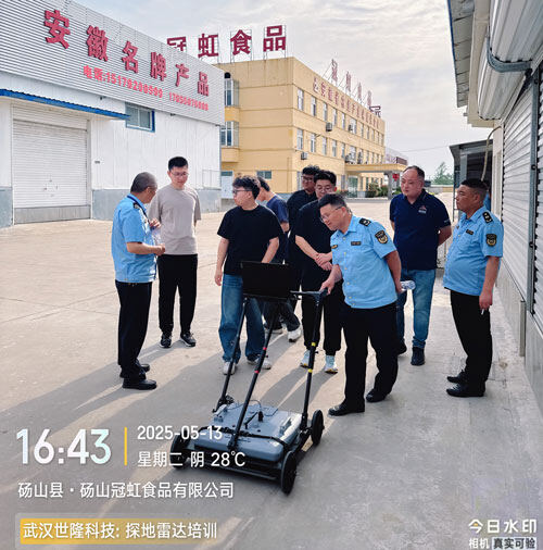 A technician demonstrates the operation of the SL-GPR ground-penetrating radar equipment to law enforcement officers at the Anhui Minghui Food Company plant.