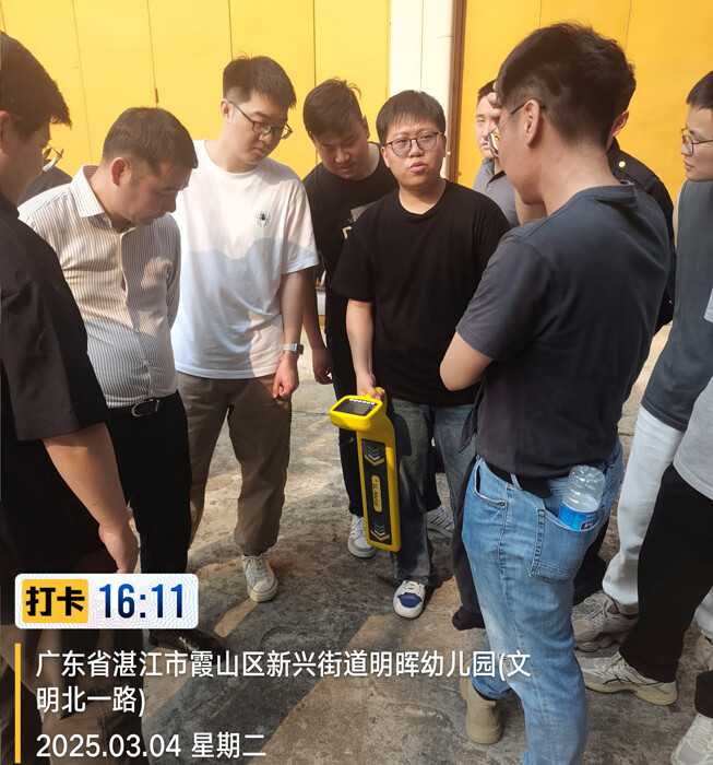 Technician demonstrates how to use the handheld detection device.