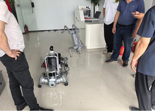 North Korean delegation tours Shilong Technology's exhibition hall, viewing four-legged robot smart equipment displays.