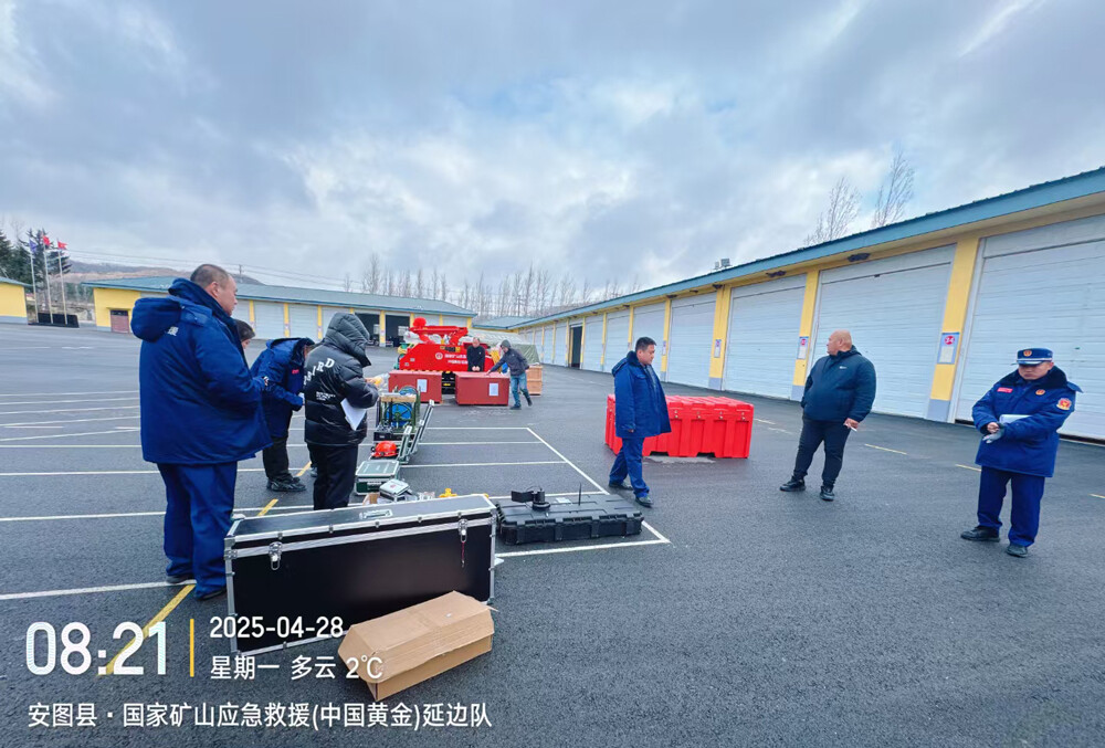 Rescue team members inspect ground-penetrating radar equipment accessories in the parking lot.