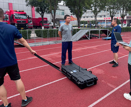A technician demonstrates the SL-TGPR ground-penetrating radar on a red track.