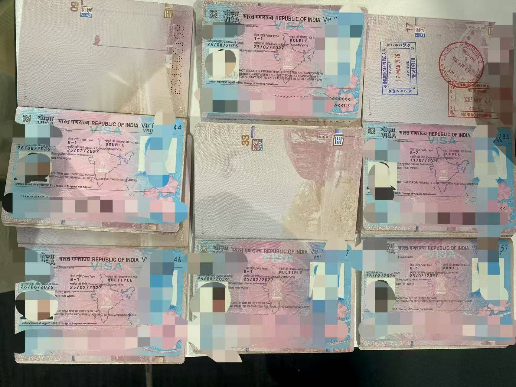 Group photo of multiple Indian visa pages issued simultaneously by the Beijing Consular District, including categories B-1 and T-1.