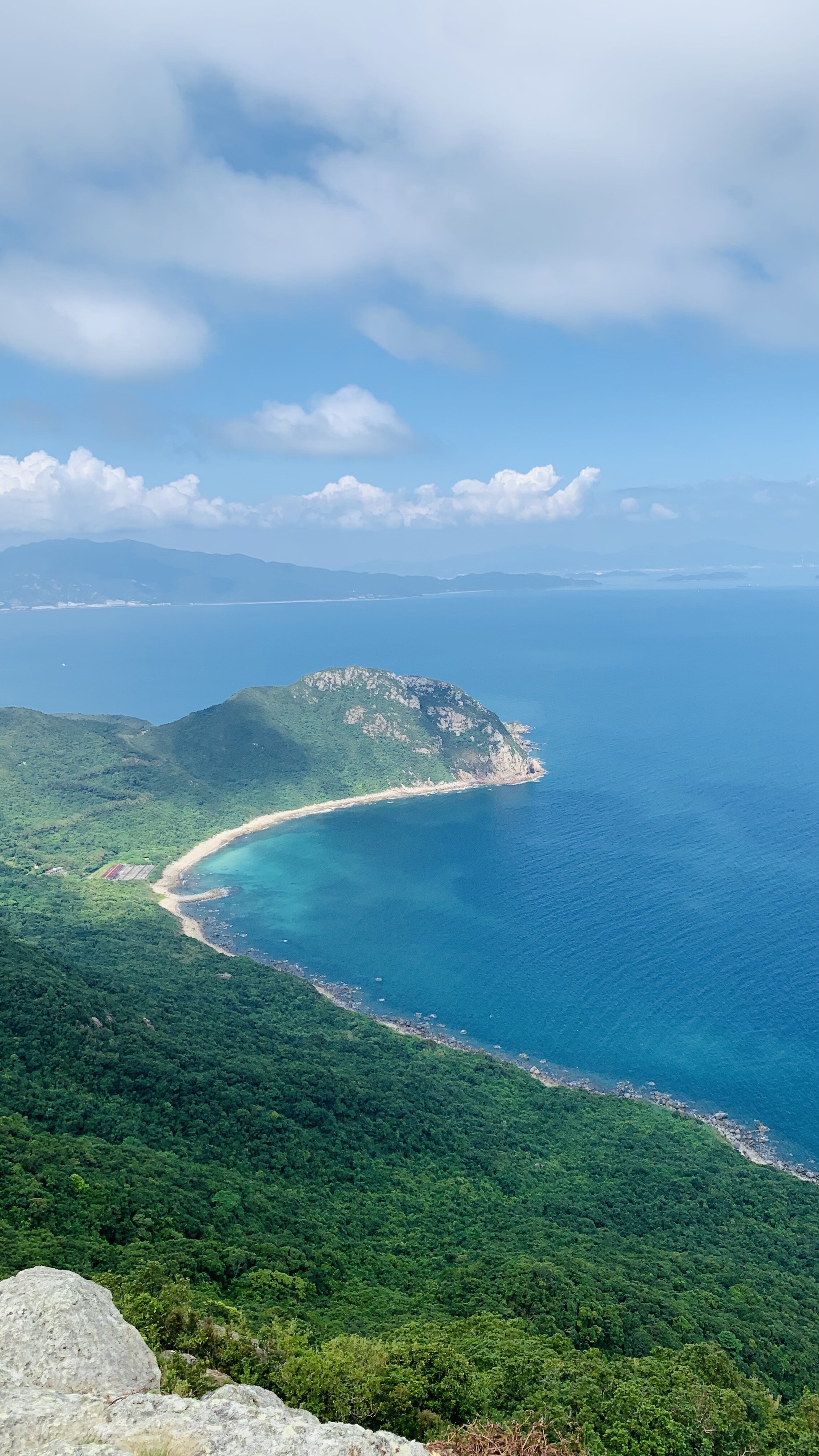 Aerial coastline where green mountains meet the sea