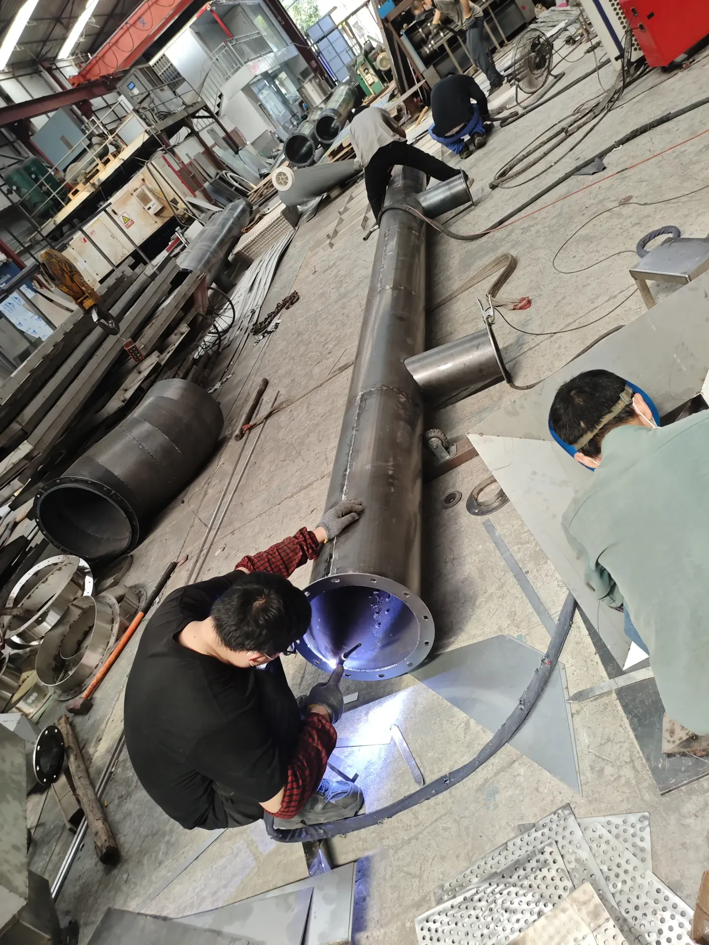 Operator working on a stainless steel tube production line