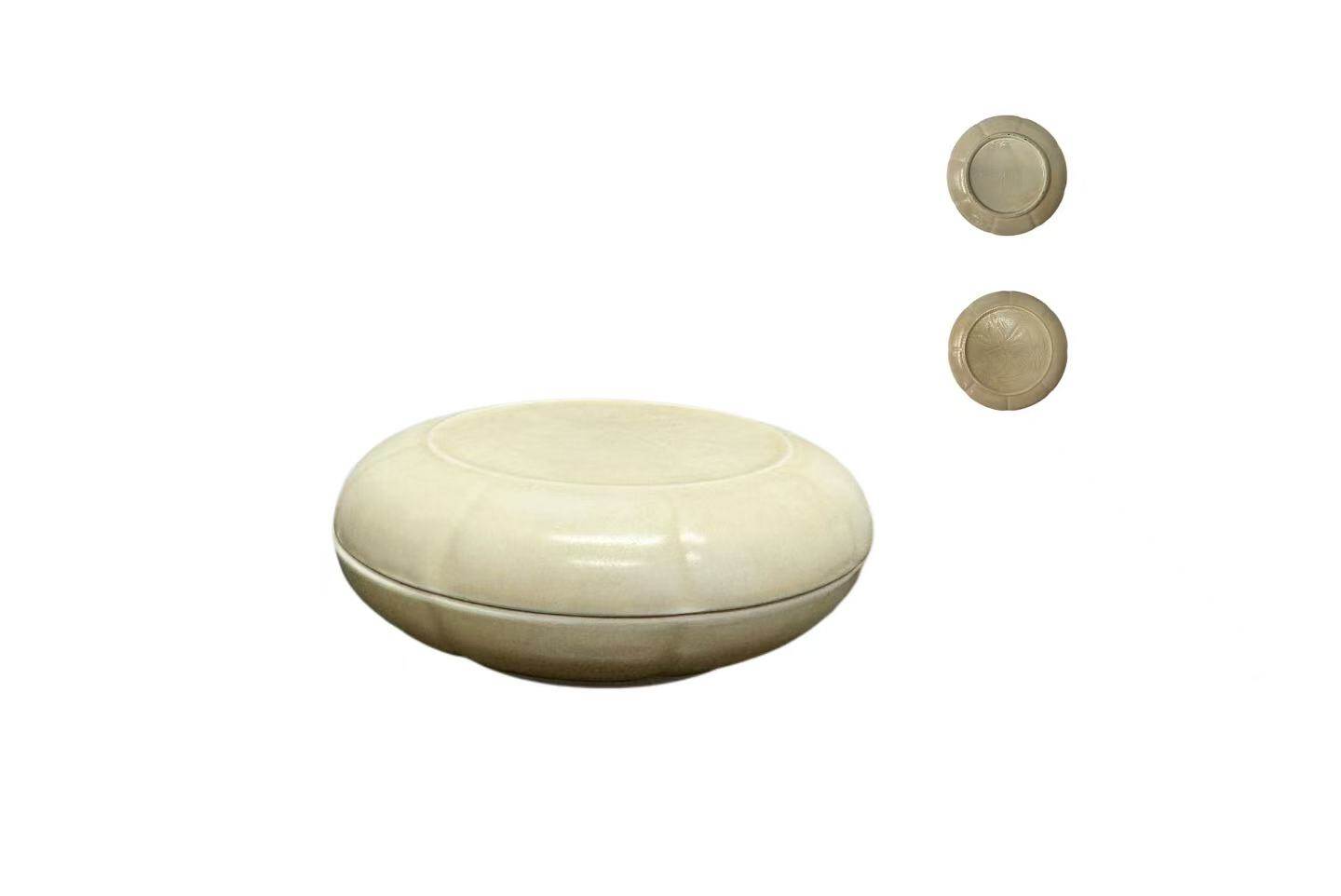 Covered box with incised and carved decoration in white glaze