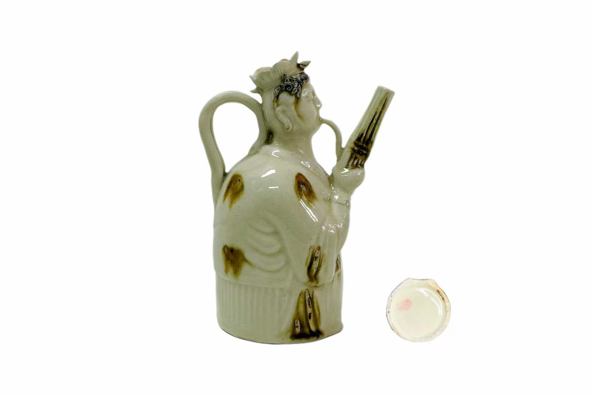 Song Dynasty White-Green Glazed Polka-Dot Immortal Playing a Flute and Holding a Ewer