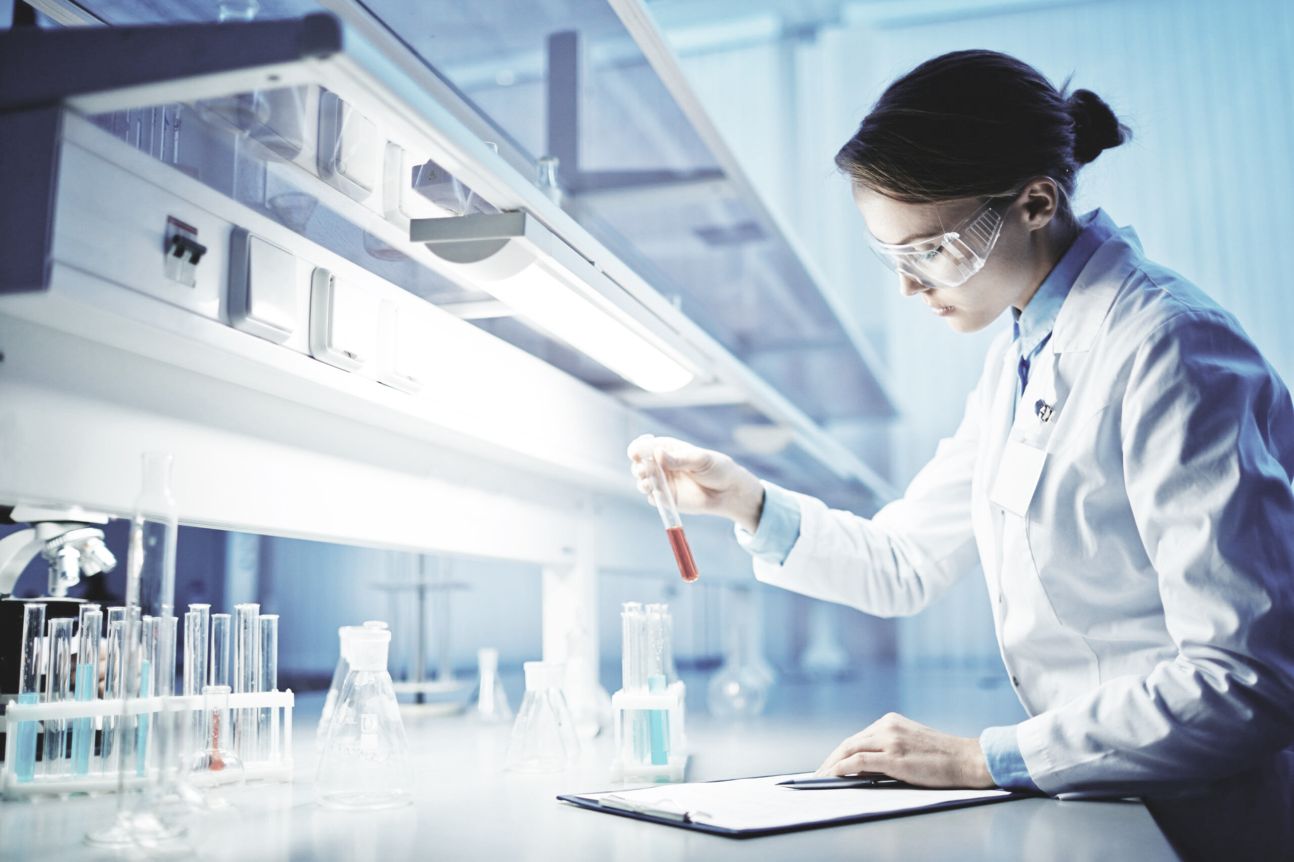 Researcher using microscope in laboratory