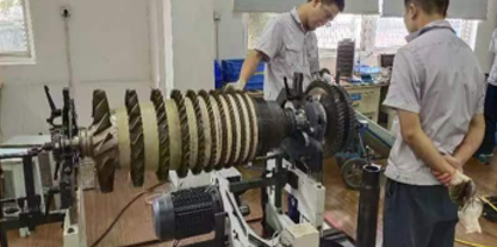 Technician inspects turbine rotor component