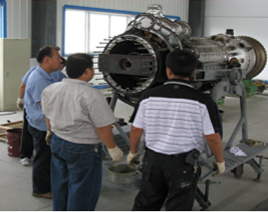 Technician servicing gas turbine equipment