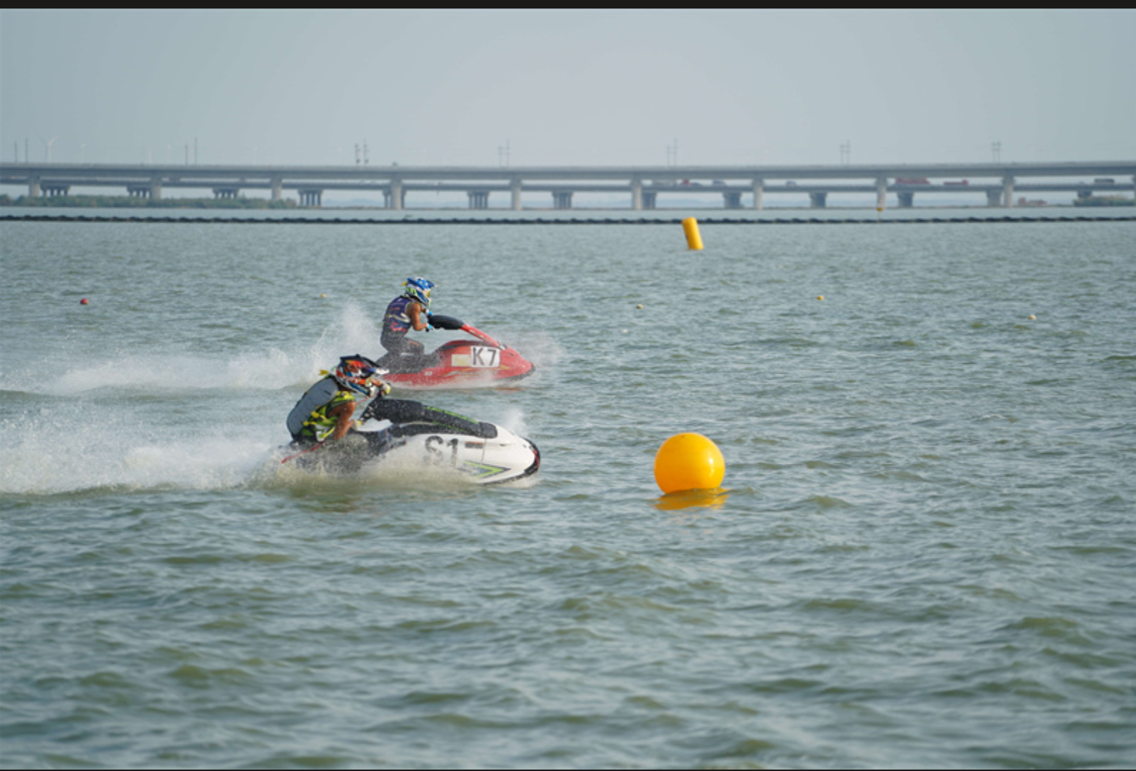 Jet ski athletes maneuvering around buoys
