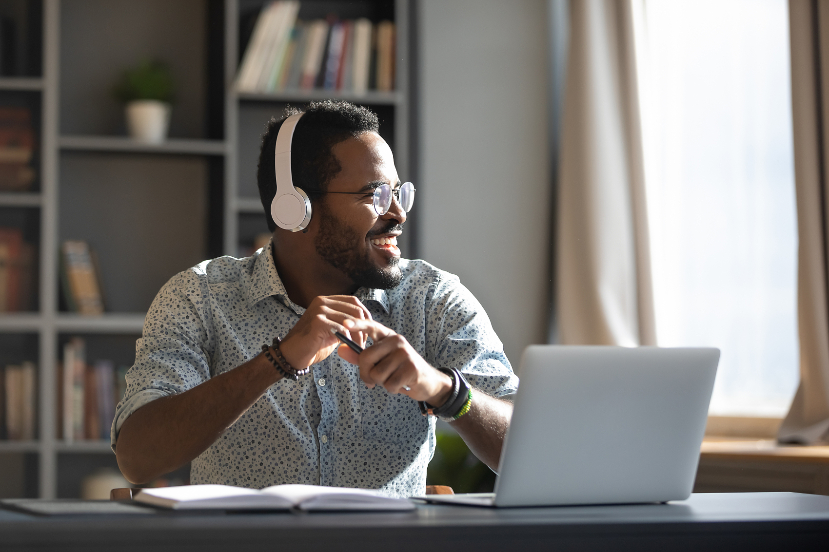 Foreign student studying online with headphones