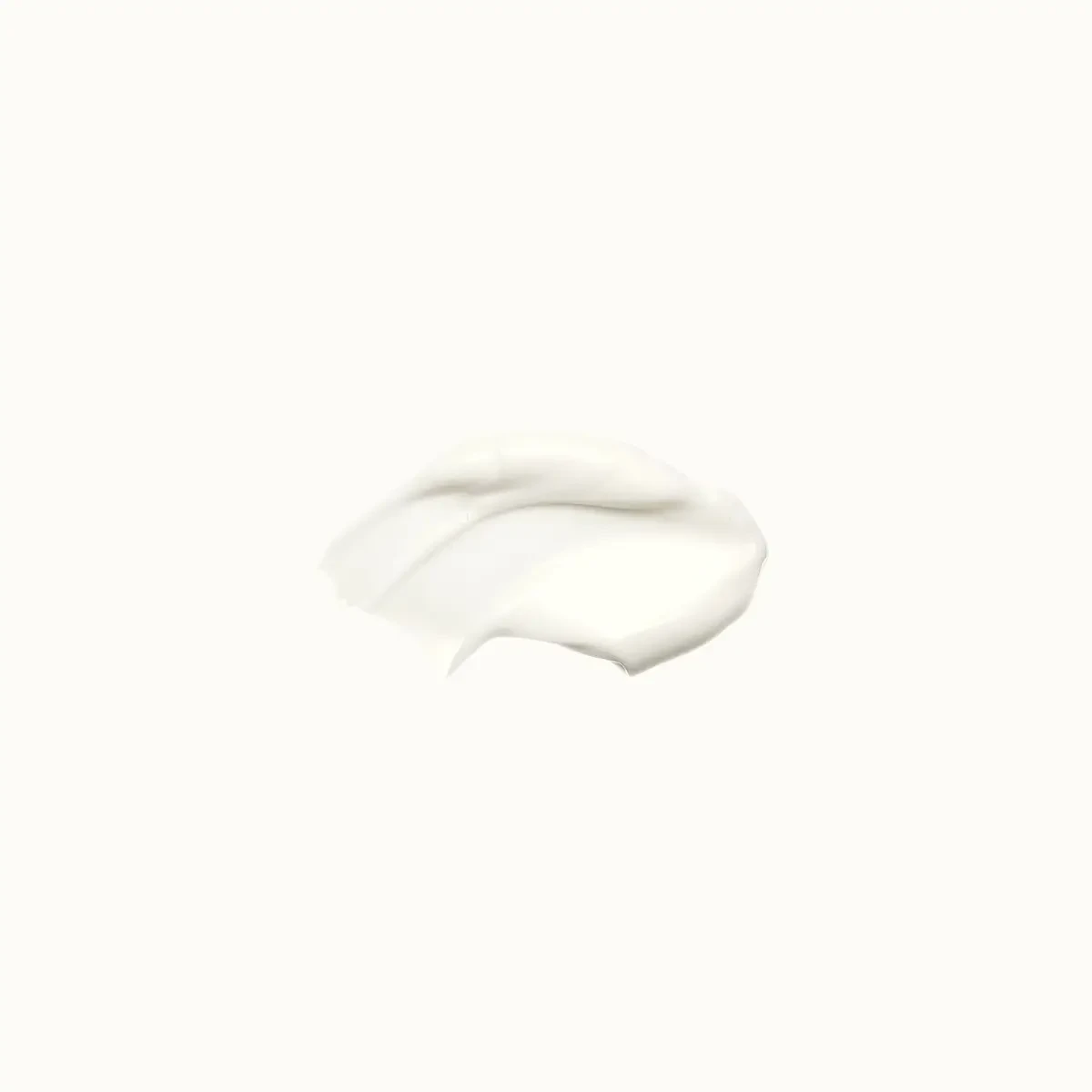Silky white serum texture swatch on a white surface