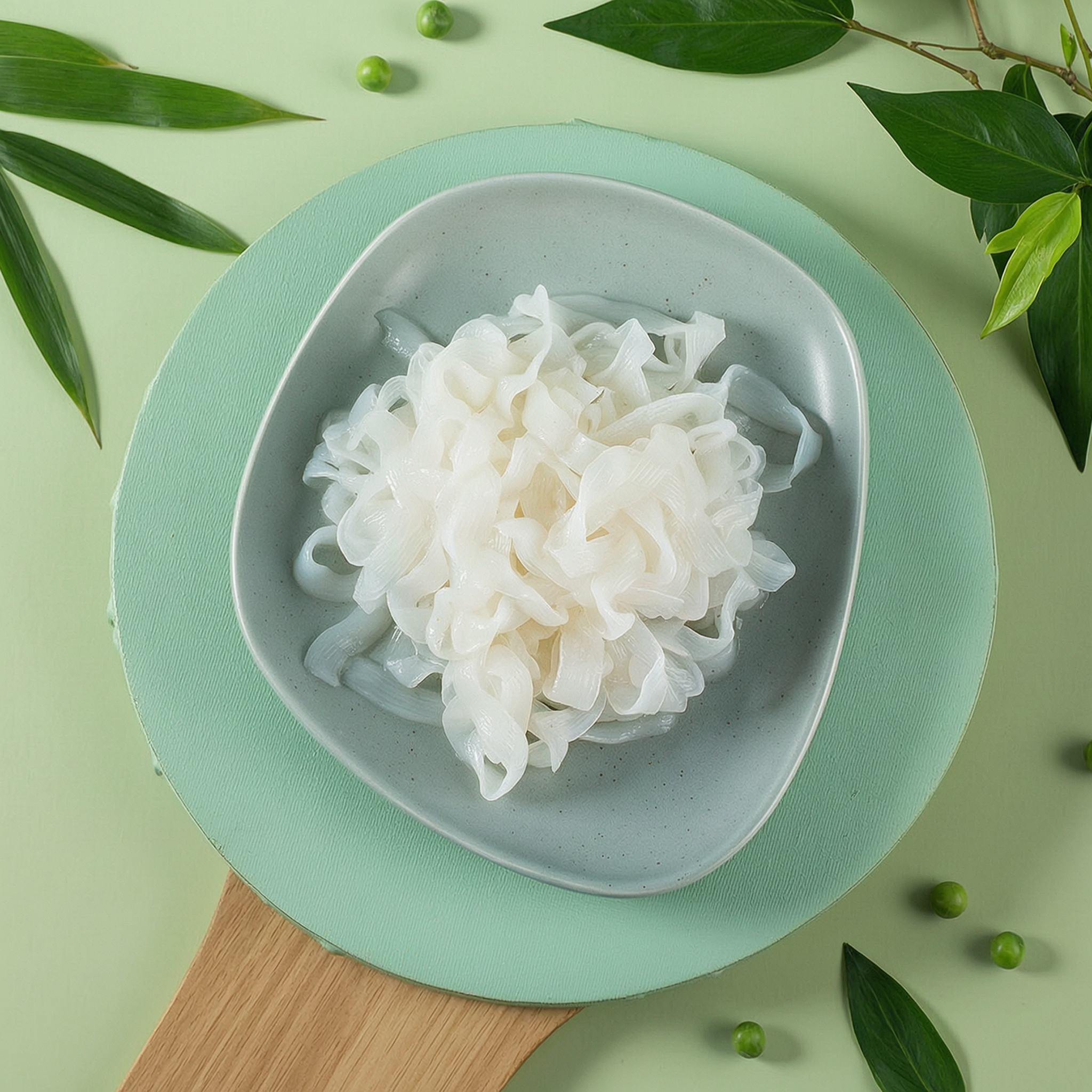 Wide konjac tagliatelle noodles on a white plate