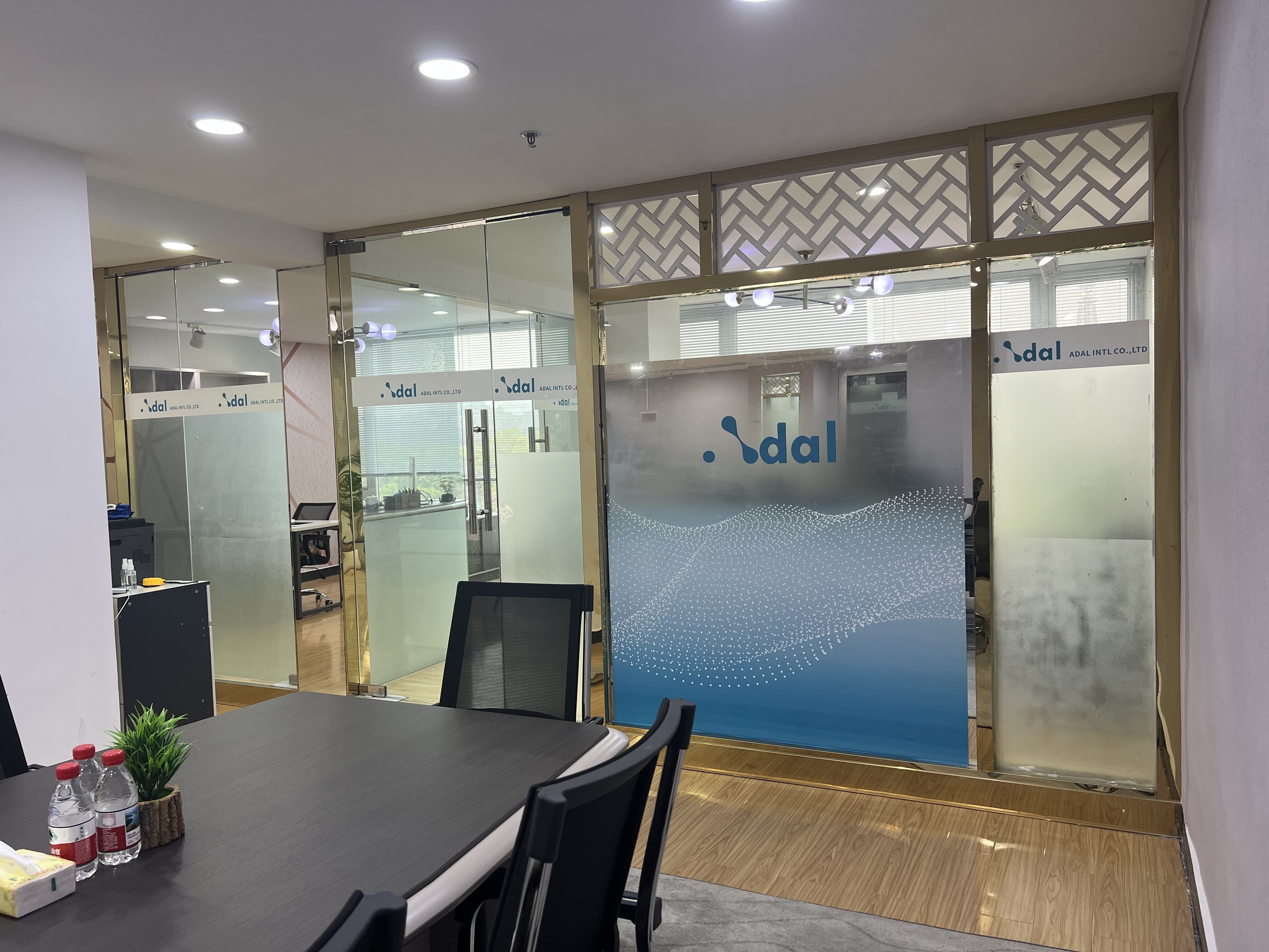ADAL office glass partition with company branding