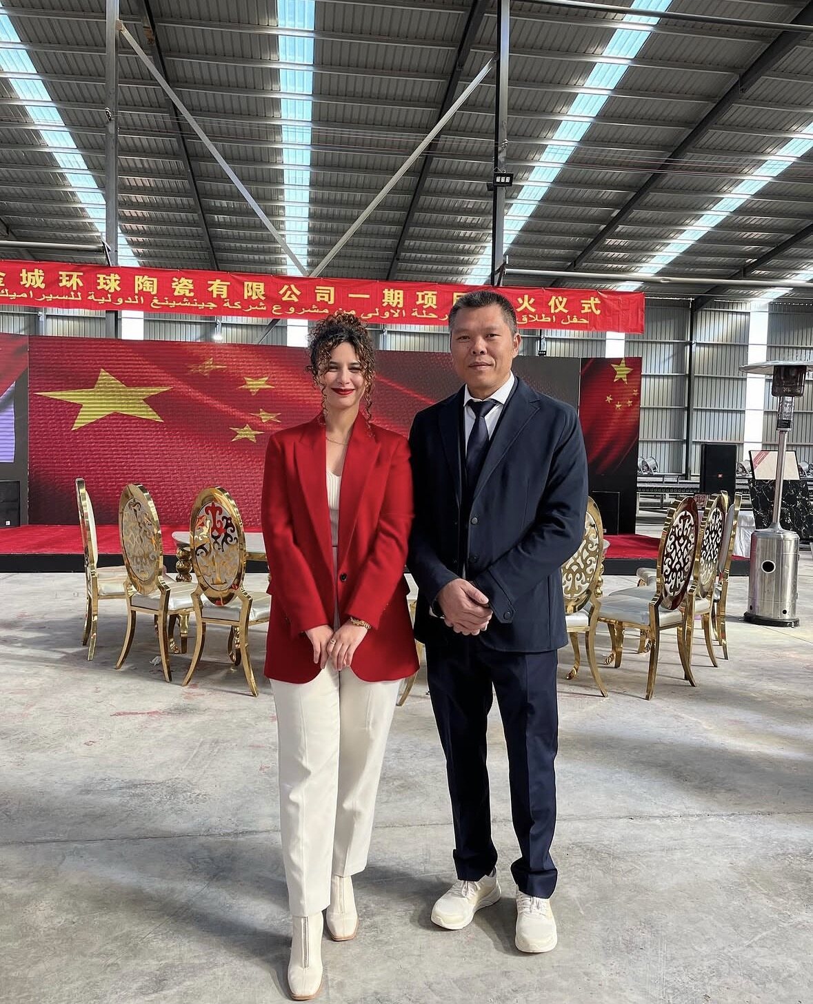 Founder posing with a factory director at a kiln ignition ceremony