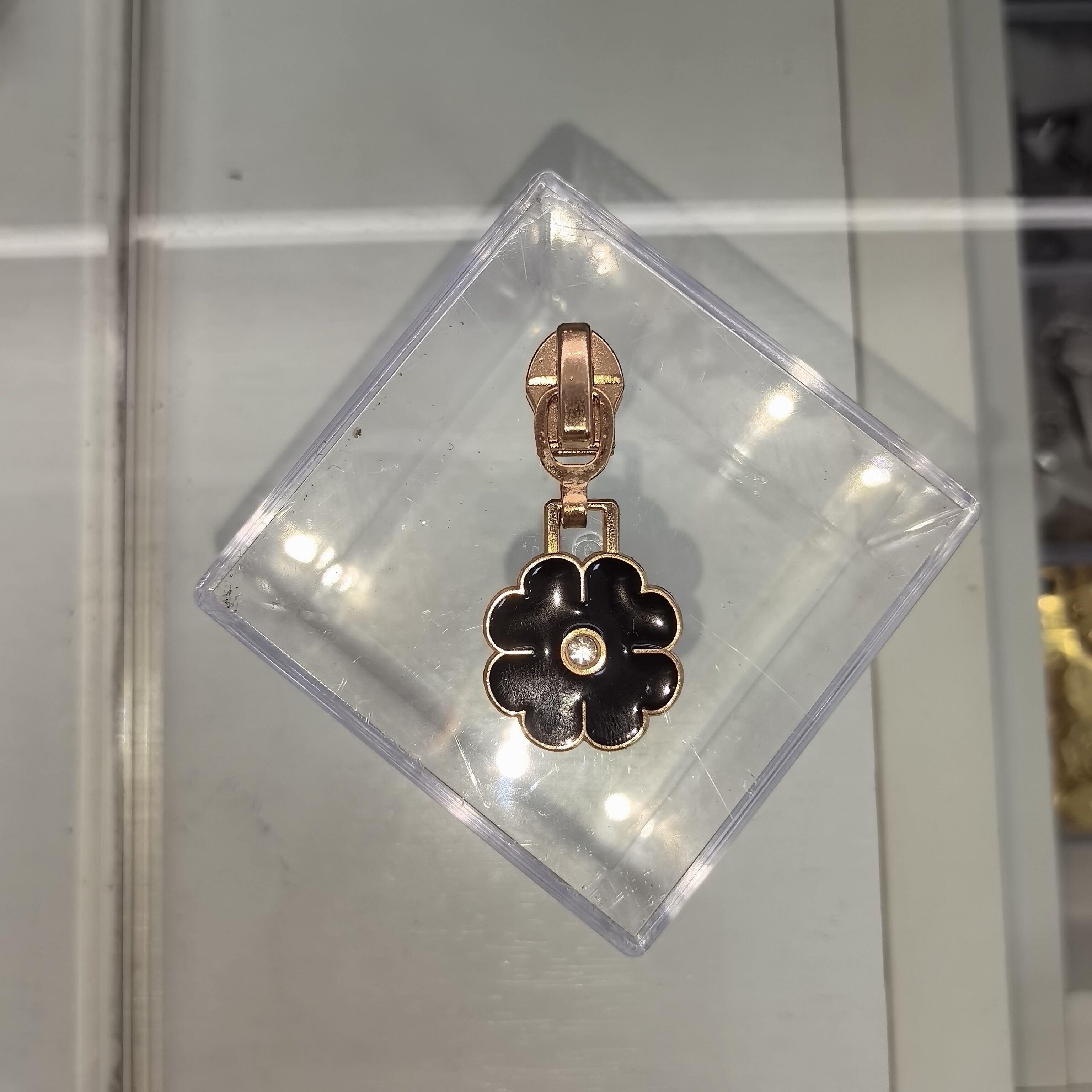 Black and floral diamond-embellished zipper pull
