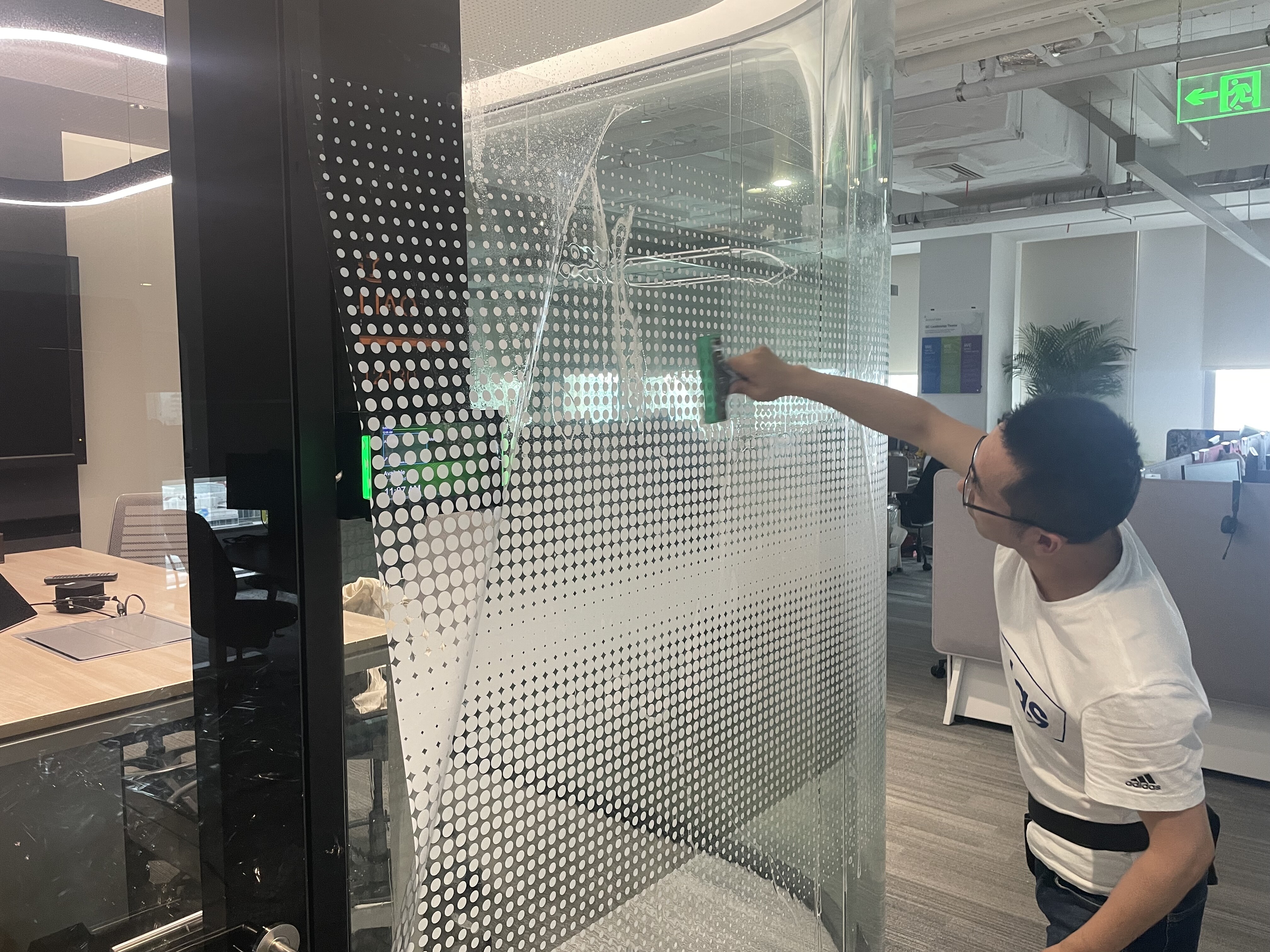 Nano Cloaking Film professional installation on large glass panel at Illumina
