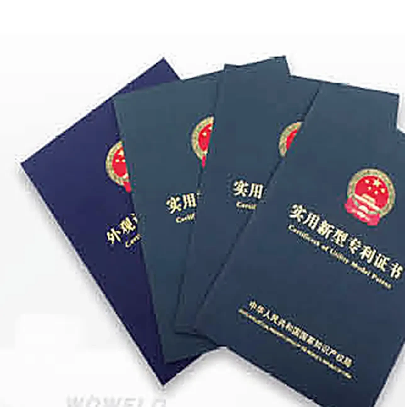 Four patent certificate covers held by the manufacturer, three utility model and one design patent