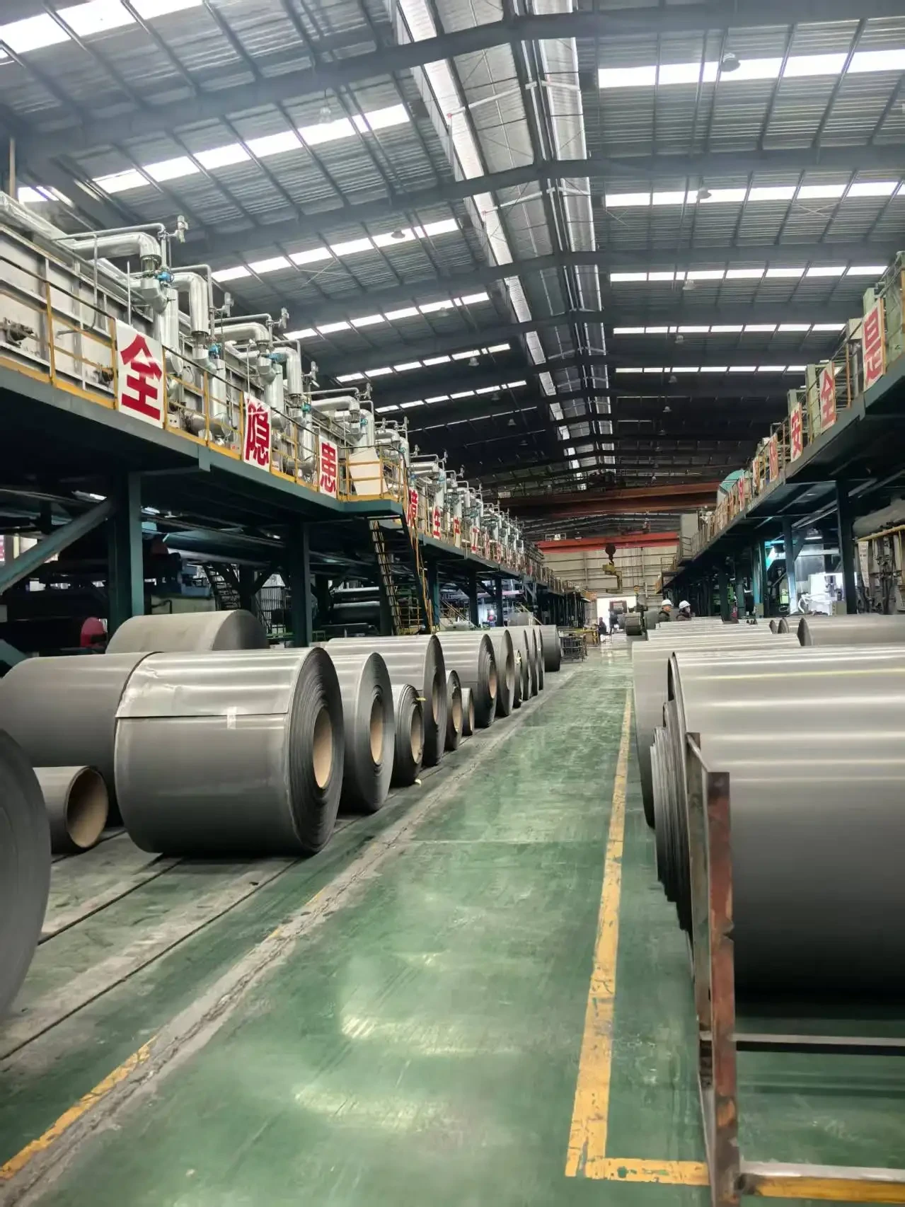 Electrical steel coils stored in rows inside a production workshop