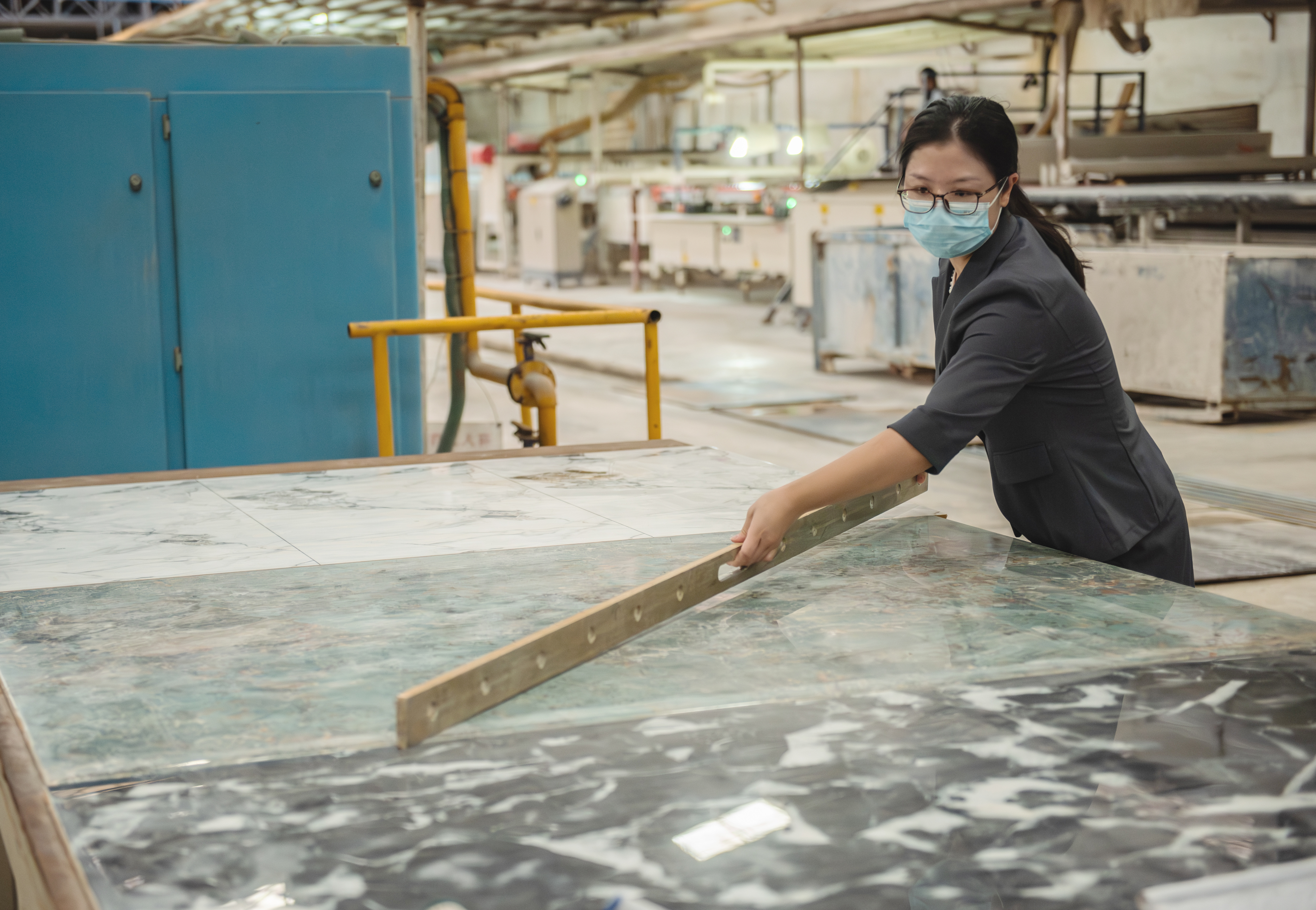 Client inspecting tile samples in factory